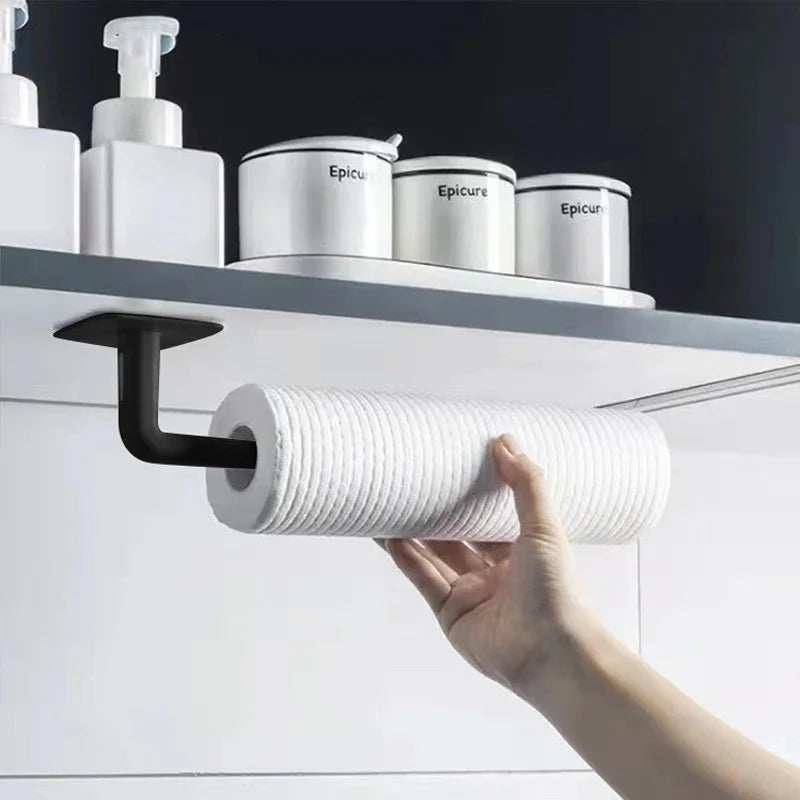 A hand is pulling a white roll of no-punch adhesive hooks from a shelf displaying various white containers.