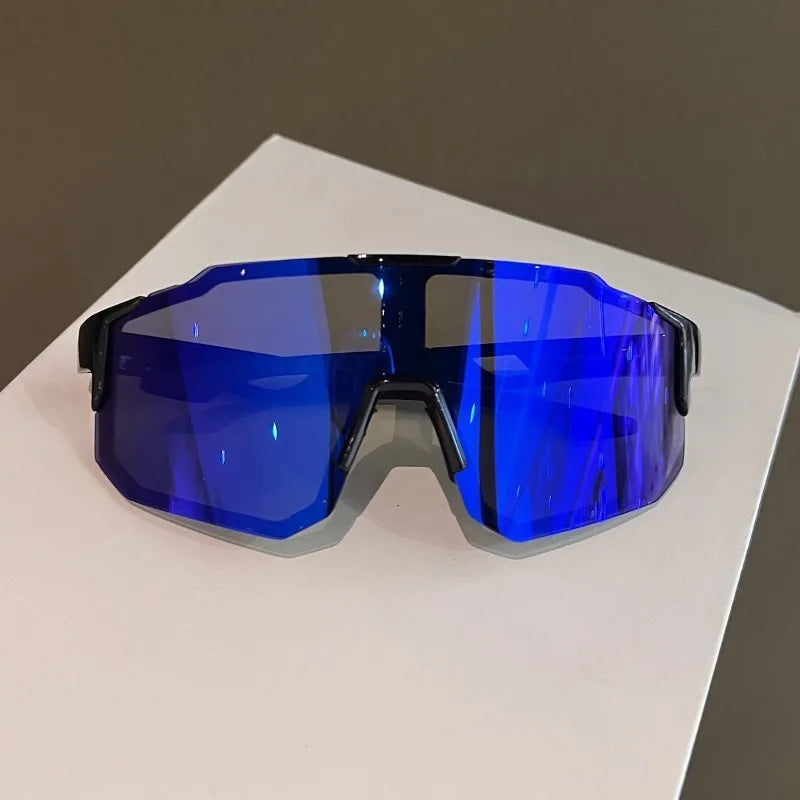 A pair of bright blue polarized sunglasses resting on a white surface.