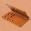 A tan ultra-thin PU leather compact wallet shown open, displaying a smooth leather interior and protective cover.