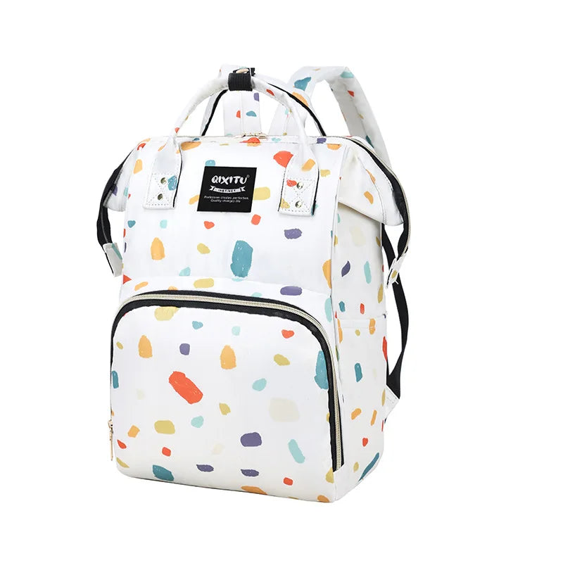 A white and colorful patterned waterproof diaper bag backpack with black straps and storage pockets.