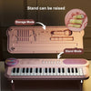 A pink electronic keyboard piano with a microphone, showing storage and stand modes.