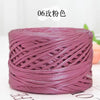 A spool of metallic pink flat ribbon yarn for crochet and knitting