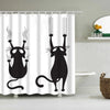 A black cartoon cat with curled whiskers and tail is printed on a white shower curtain.