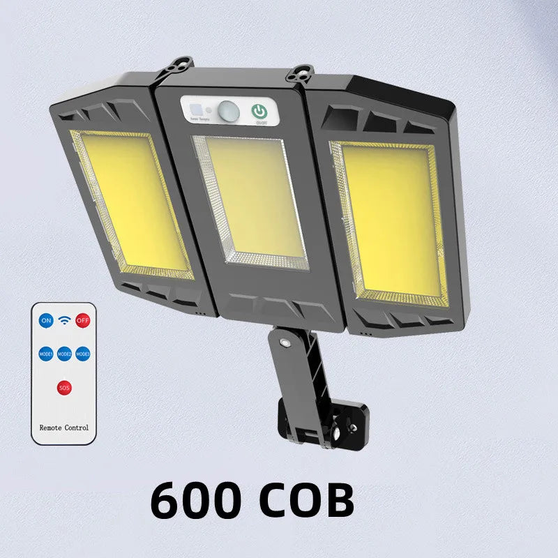 A black outdoor wall light fixture with three illuminated panels and a remote control.