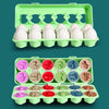 A green plastic tray holding multiple matching white eggs and various colored eggs for a Montessori toy set
