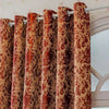 A set of textured, reddish-brown tree bark jacquard blackout curtain panels hanging on a white rod.