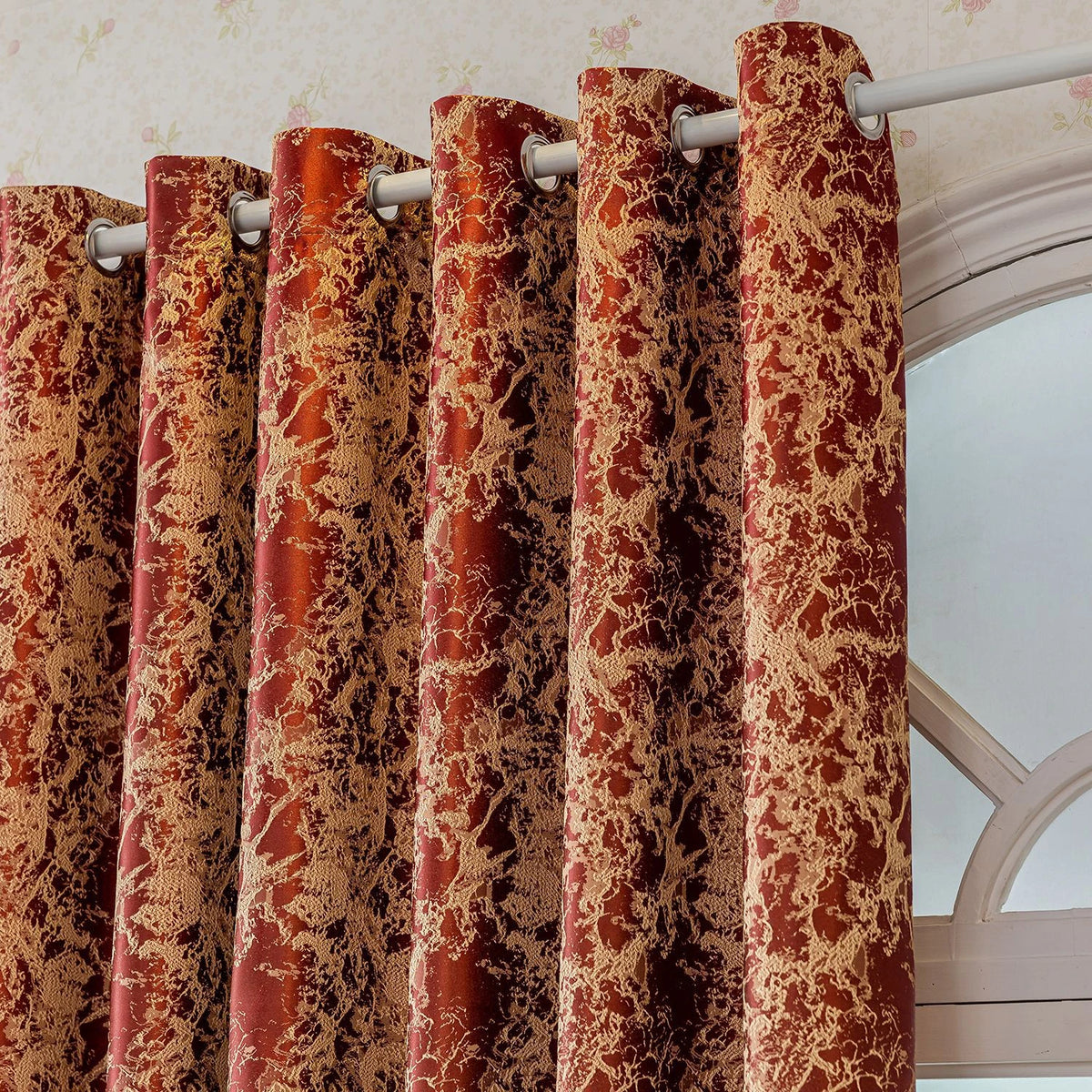 A set of textured, reddish-brown tree bark jacquard blackout curtain panels hanging on a white rod.
