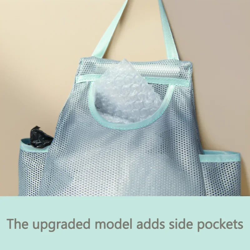 Light blue mesh garbage bag holder with a clear plastic bag and side pockets
