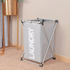 A large gray foldable laundry basket with a mesh top is displayed next to a wooden stand.