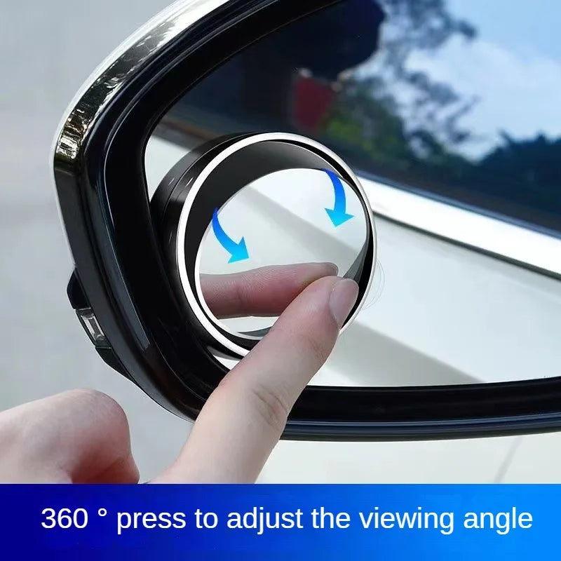 A hand adjusts the viewing angle of a black blind spot mirror for a car rearview device.