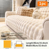 A beige plush anti-slip sofa cushion cover displayed on a sofa with decorative pillows.