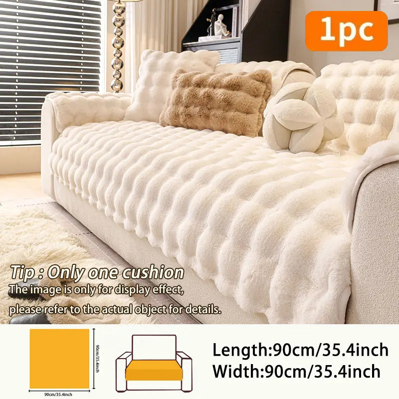 A beige plush anti-slip sofa cushion cover displayed on a sofa with decorative pillows.