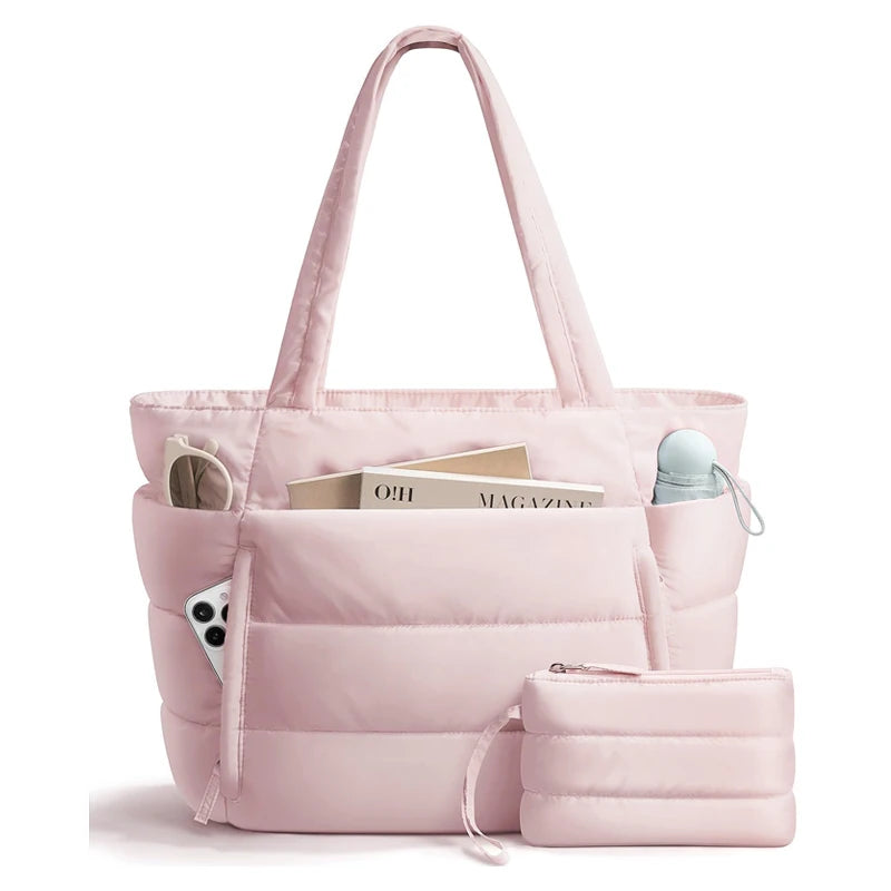 A pink quilted puffy tote bag with a laptop sleeve is shown in a studio setting.