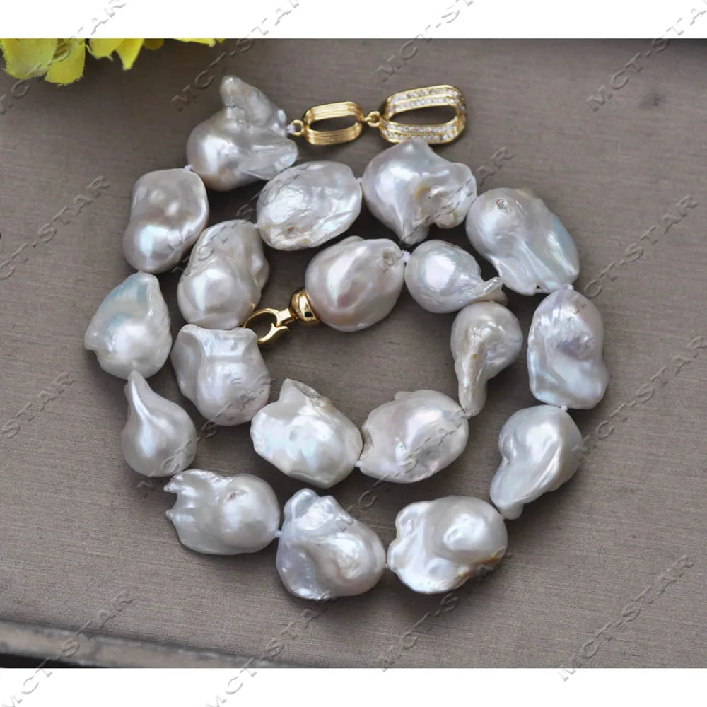 A necklace featuring white baroque keshi pearls strung together with a gold-toned clasp.