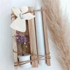 Angel-shaped silicone mold for resin and crafting displayed with a white candle and dried grass