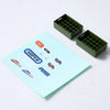 A set of green plastic accessories for an RC car, including various shapes like a surfboard, kayak, and roadblocks.