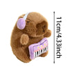 A brown capybara plush toy with a white headband and a purple guitar accessory, shown against a white background.