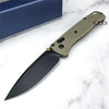 A folding pocket knife with a drop point blade in a light olive green color resting on a white marble surface.