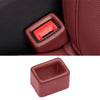 A close-up view of a reddish-brown car seatbelt buckle protective cover with a red insert.
