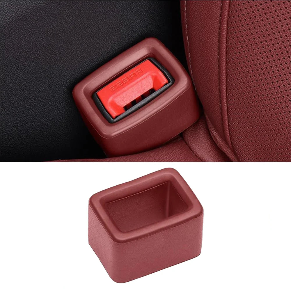 A close-up view of a reddish-brown car seatbelt buckle protective cover with a red insert.