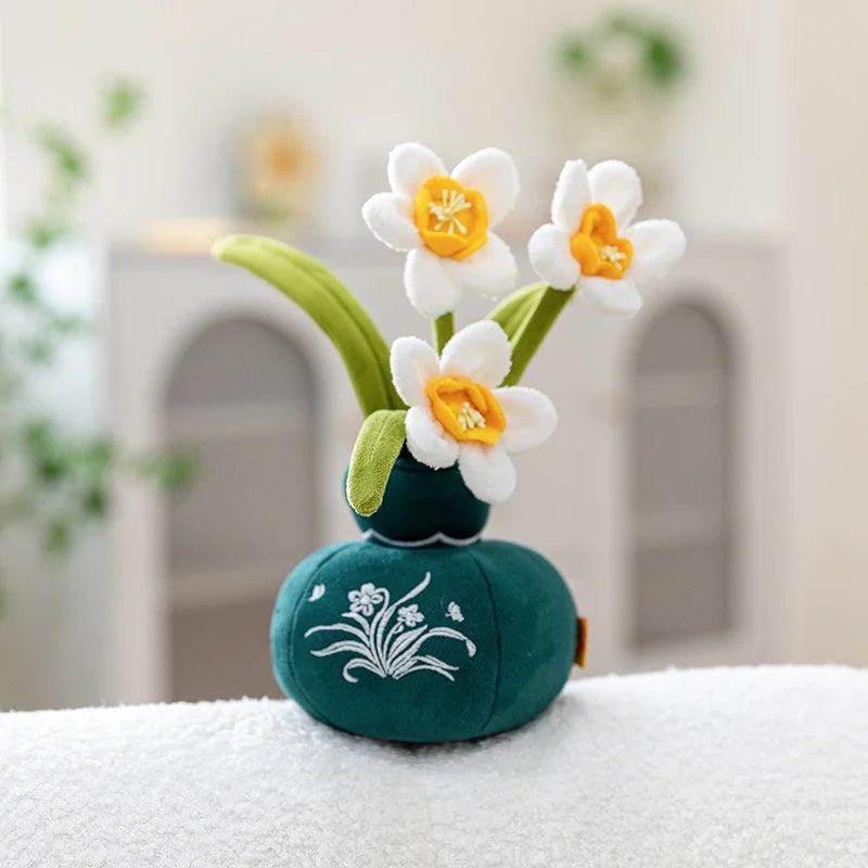 A small artificial flower plush doll with white petals and yellow centers is displayed on a white surface.