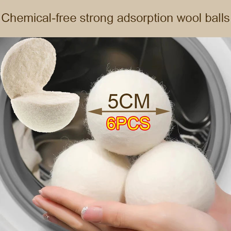 A hand holds several white wool dryer balls inside a washing machine drum.