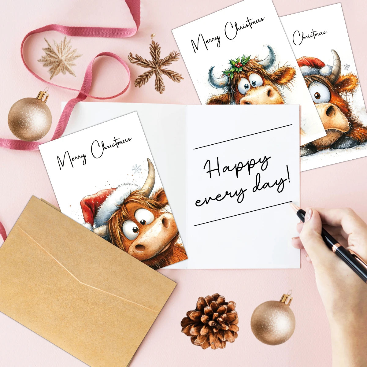 A set of adorable Highland cow Christmas cards and envelopes with festive holiday decorations