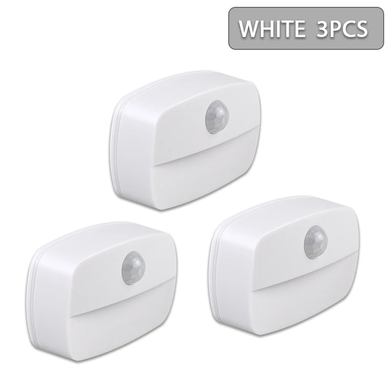Three white motion sensor LED night light components shown from above.