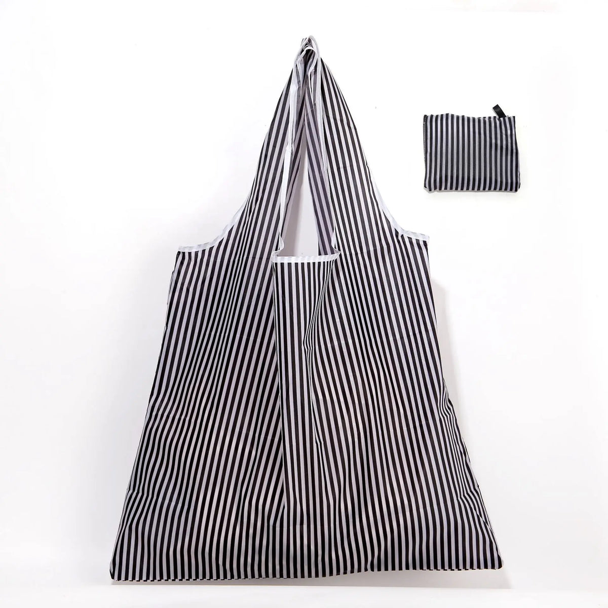 A black and white striped foldable reusable shopping tote with an attached carry pouch.
