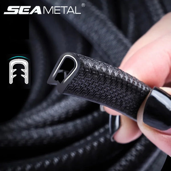 A hand holds a black door edge protector strip with a textured surface, demonstrating the product.