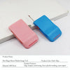 Pink and blue plastic sewing gauge tool with ruler and seam ripper visible on a white surface.