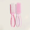 A set of pink nail art brushes with long handles, including a flat brush and a fine-tipped brush.
