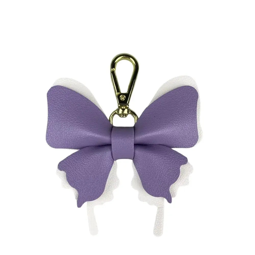 A purple PU leather butterfly bag charm with a gold-toned clasp.