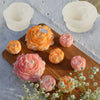 A collection of pink and orange 3D peony flower silicone molds for crafting candles, resin, and soap.