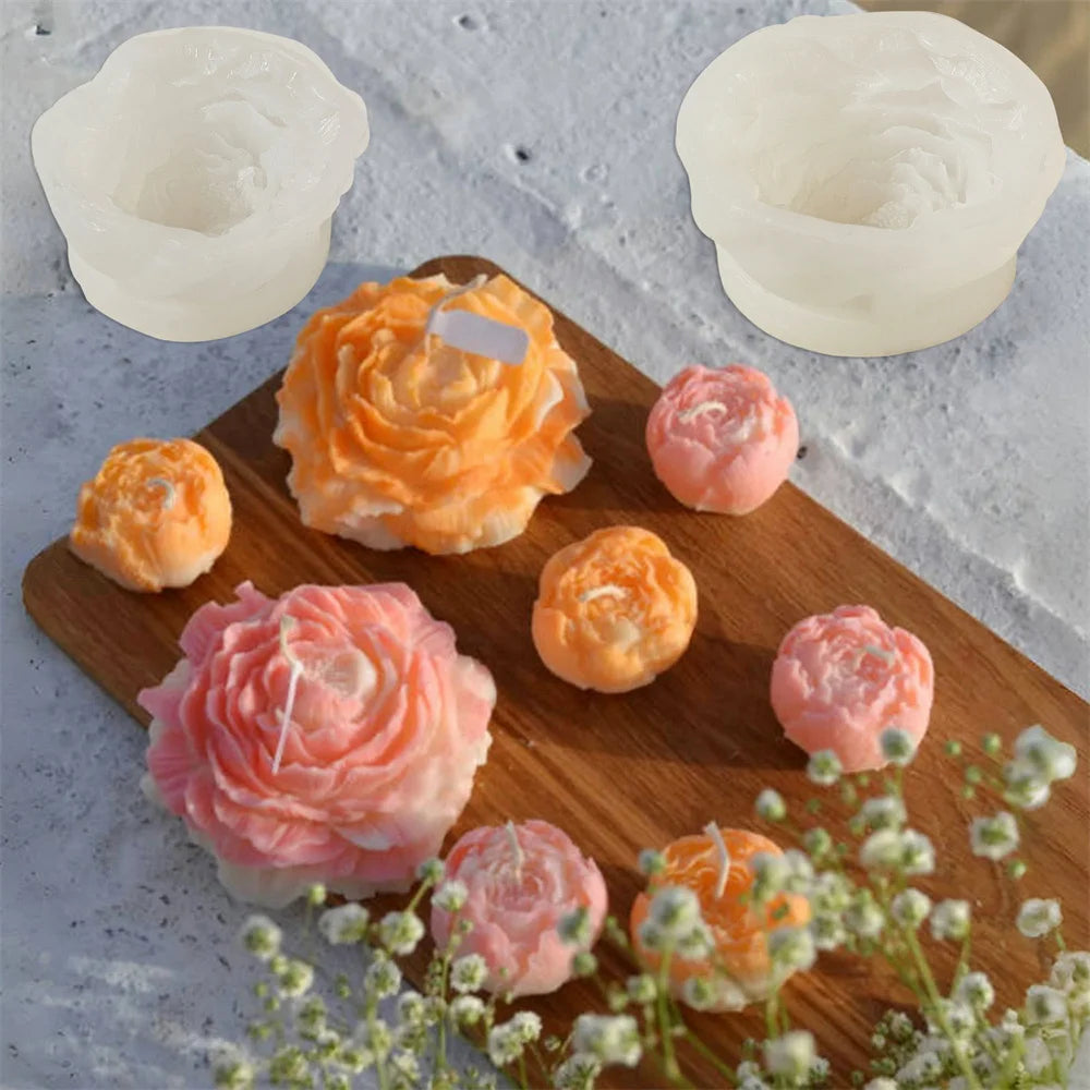 A collection of pink and orange 3D peony flower silicone molds for crafting candles, resin, and soap.