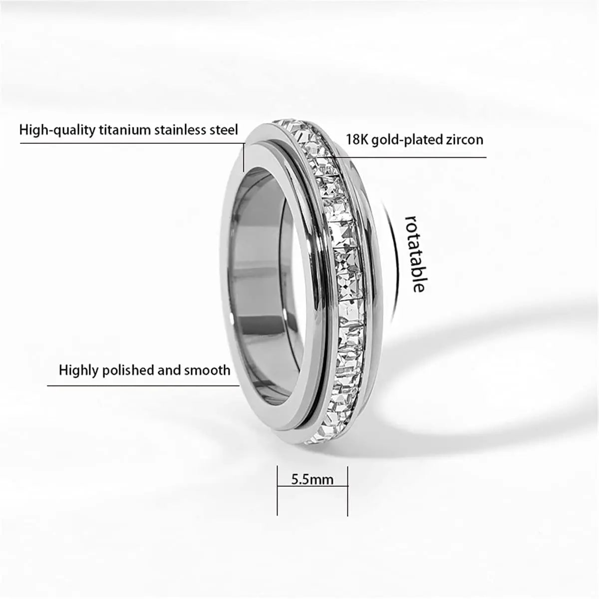 A close-up view of a silver titanium steel ring with 18K gold-plated zircon stones, showing its smooth finish and rotatable d