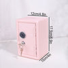 A pink vintage metal piggy bank with a combination lock and key, shown from the side.