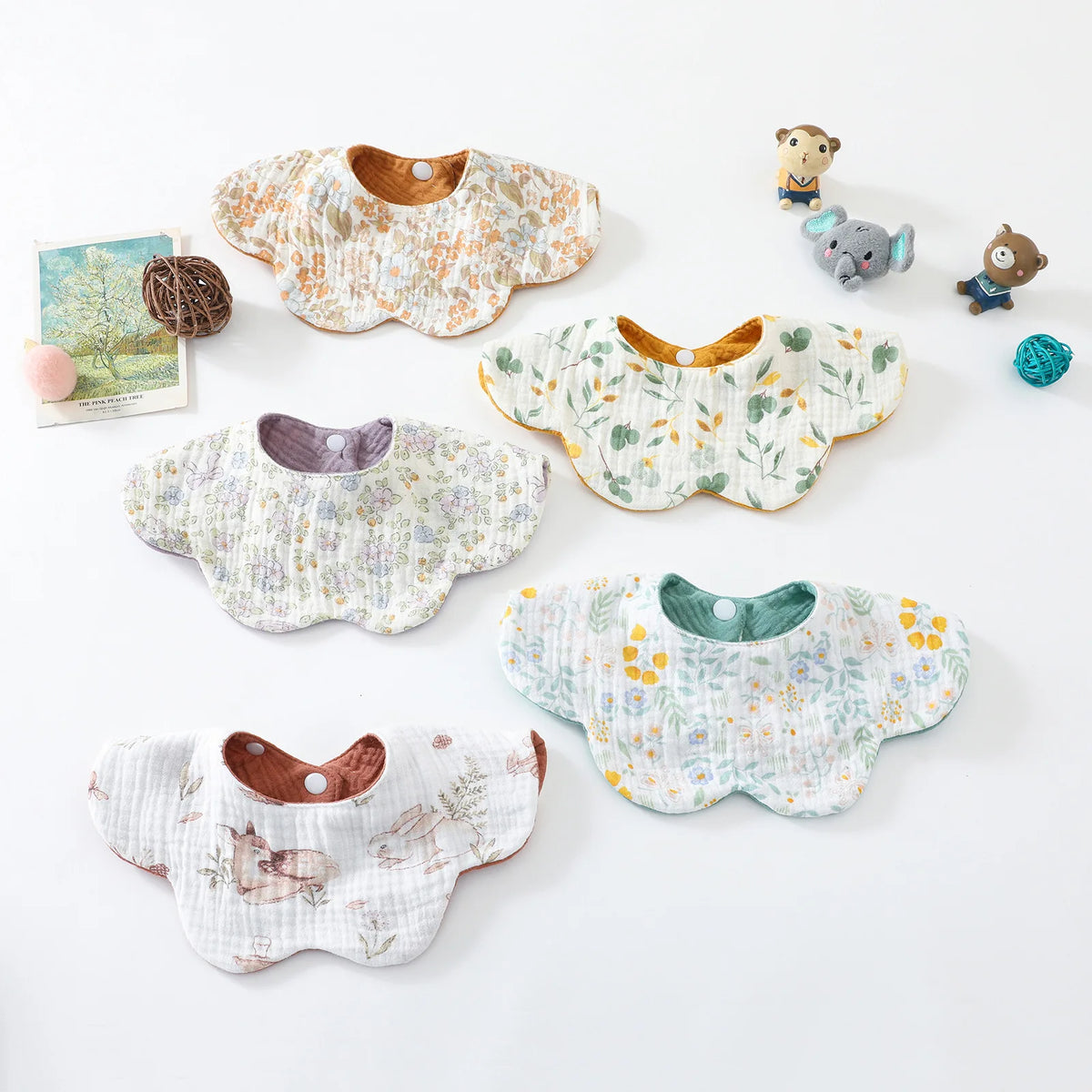 A collection of six-layer cotton baby feeding bibs featuring various floral and animal prints.