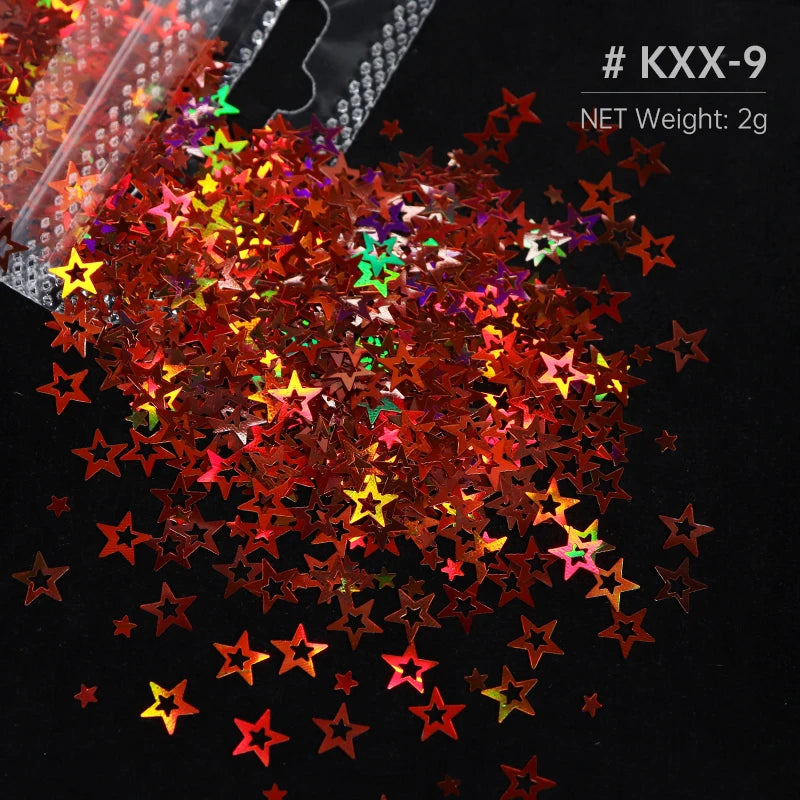 A pile of shiny holographic star sequins in various colors like red, orange, green, and purple on a dark surface.