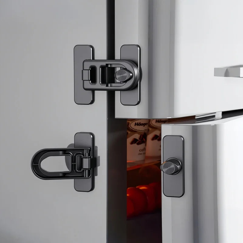 Close-up of a modern stainless steel non-drill child safety door lock installed on a kitchen appliance cabinet.