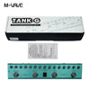 A box and a teal guitar pedal labeled TANK-G showing various controls for guitar effects.