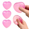 Pink heart-shaped stress relief squeeze toys being held by a hand