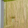 A sheer gold tassel string curtain hanging vertically, used as a room divider or doorway drape.