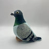 A plush toy of a gray pigeon with green and white feathers, featuring a dark beak.