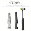 A silver ring amplifier tool shown next to a hammer and various sizing components.