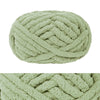 A ball of light green chunky chenille yarn used for hand knitting and crochet