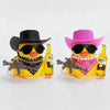 A yellow rubber duck character wearing a cowboy hat and sunglasses is shown with toy guns and bottles on a white background.