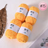 A stack of bright yellow Milk Cotton yarn skeins for knitting and crochet projects.