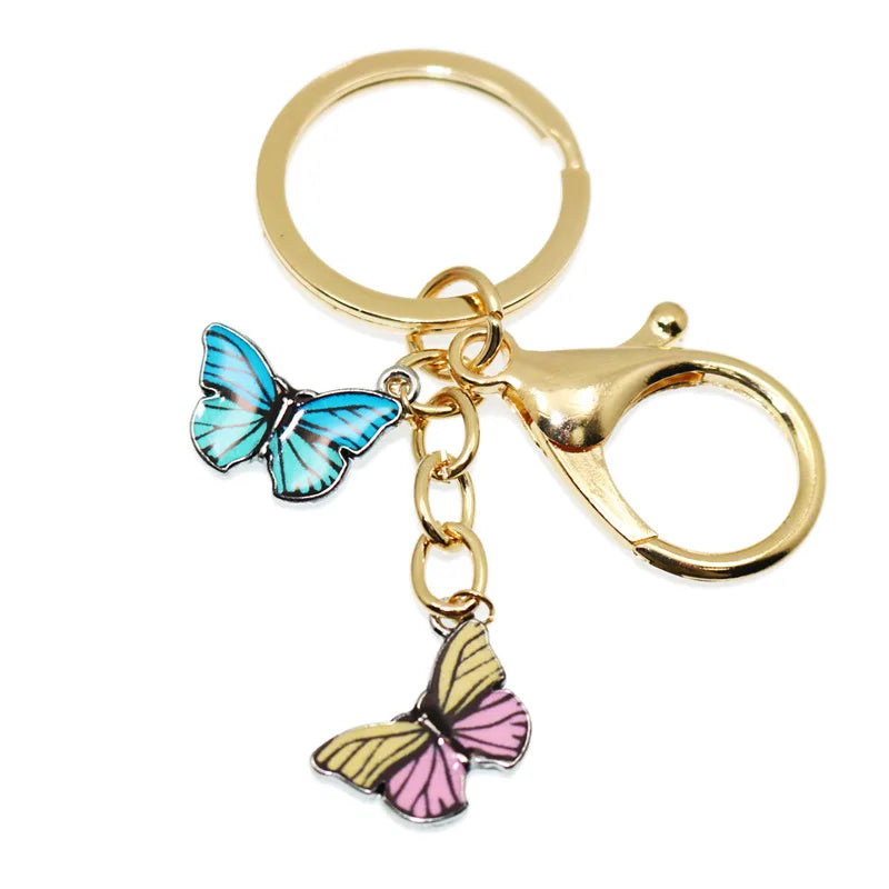 Gold-toned butterfly keychain charm with blue and pink wings