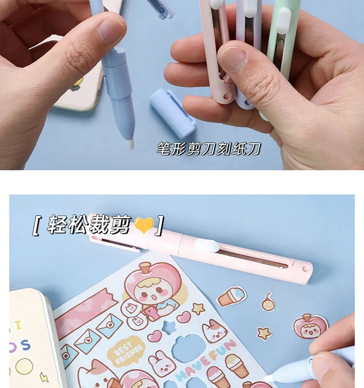 A pink folding pen-shaped safety scissor is shown resting on a sheet of craft paper with various stickers and drawings.